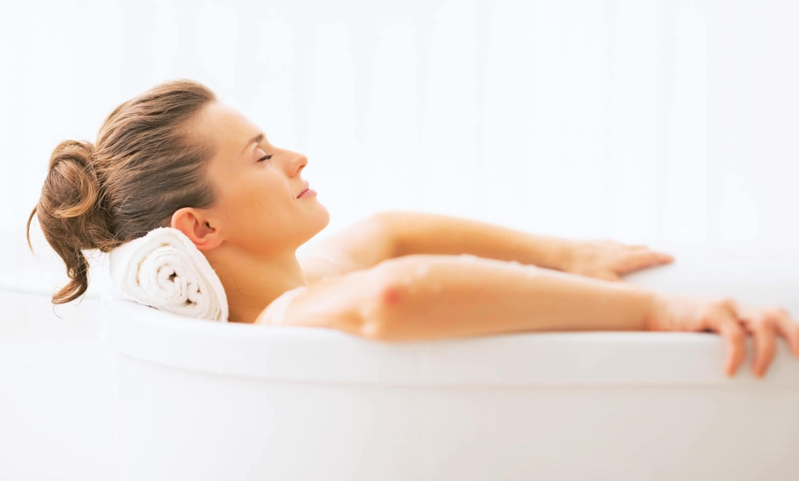 A woman in a bath enjoying a stress relief routine.