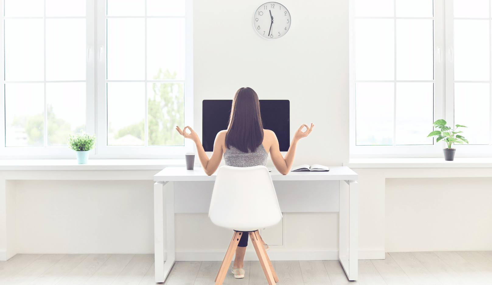 Woman meditating at her desk for Workplace Stress Management